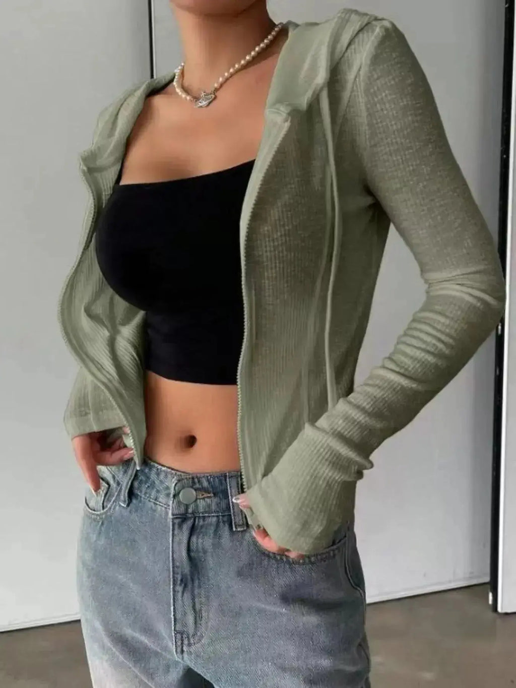 Women's ribbed knit cropped zip-up hoodie jacket by Plush Fashion Hub, featuring a hood and fitted ribbed texture.