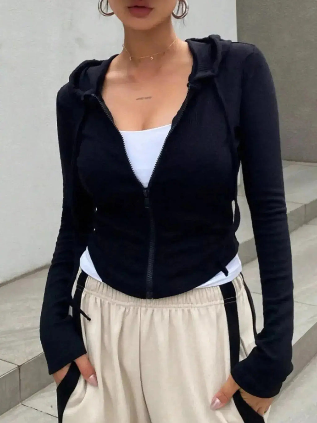 Women's ribbed knit cropped zip-up jacket with hood, stylish outerwear from Plush Fashion Hub, featuring a fitted design and cozy fabric.