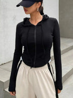 Women's ribbed knit cropped zip-up jacket with hood, stylish outerwear from Plush Fashion Hub, shown in black with front zipper detail.