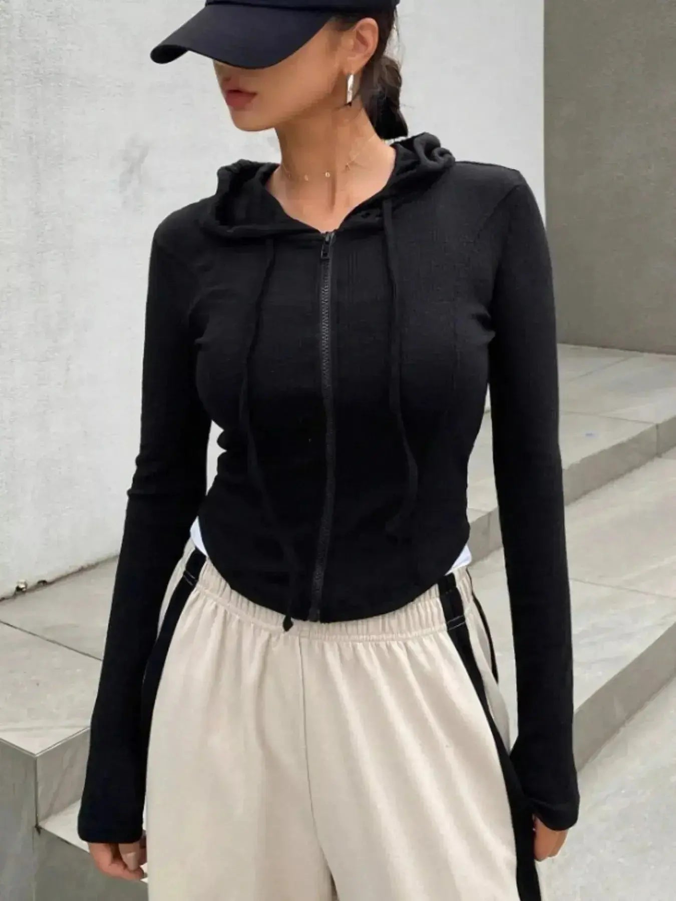 Women's ribbed knit cropped zip-up jacket with hood, stylish outerwear from Plush Fashion Hub, shown in black with front zipper detail.