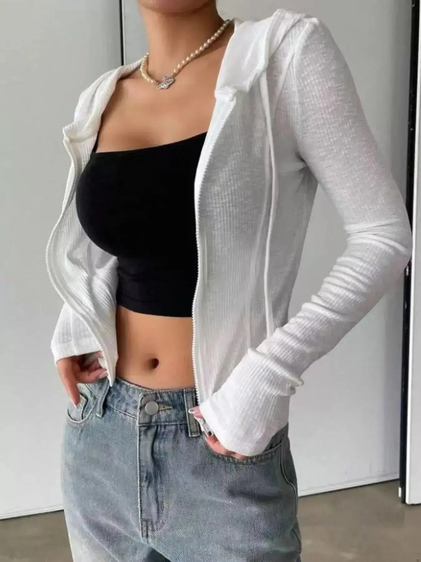 Women's ribbed knit cropped zip-up hoodie jacket by Plush Fashion Hub, featuring a front zipper and hood, perfect for casual outerwear.