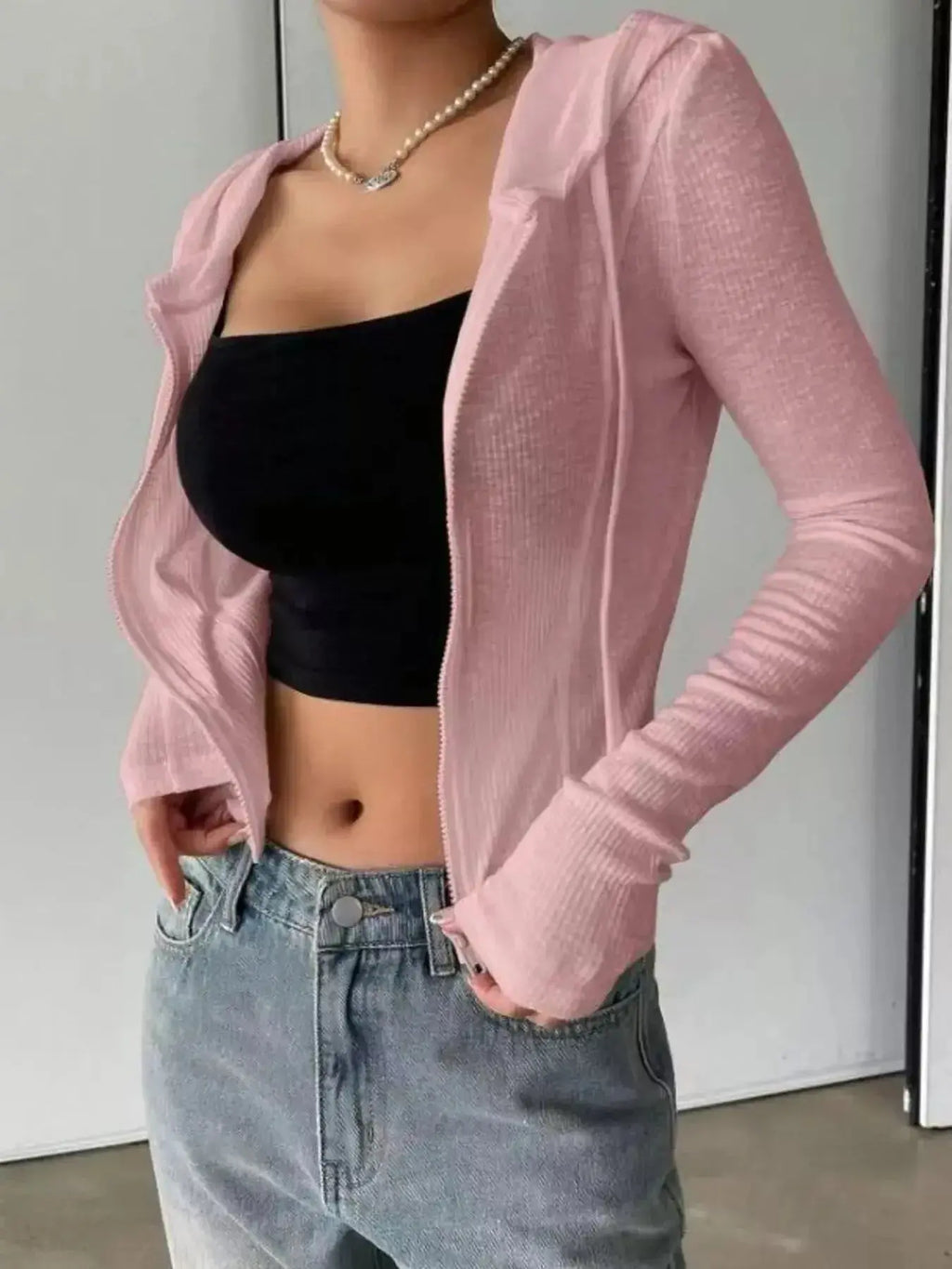 Women's ribbed knit cropped zip-up jacket with hood by Plush Fashion Hub, featuring a fitted design and cozy texture.