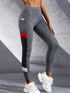 Black colorblocked mesh high-waist yoga leggings with side pockets from FitiqueFit activewear, designed for comfortable exercise wear.