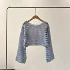 Woman wearing a plush fashion hub crochet knit beach cover-up, casualwear, with a relaxed fit and intricate crochet pattern.