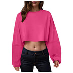 Women’s long sleeve loose-fit crop top by Plush Fashion Hub, casualwear, shown in a neutral color, with a relaxed fit and stylish design.