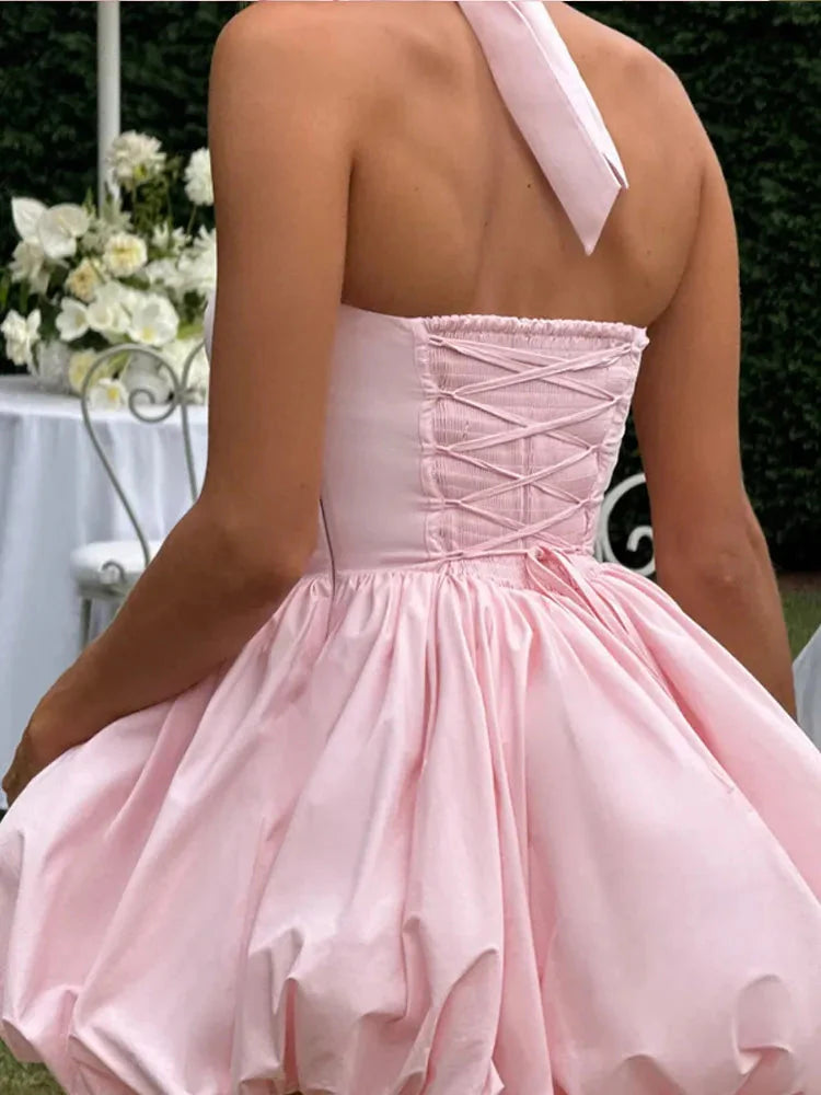 Pink women’s corset mini dress with puffball hem, casualwear by FitiqueFit, featuring a fitted bodice and stylish silhouette.