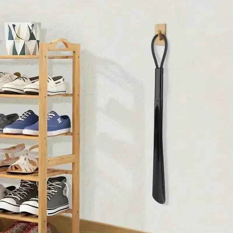 Flexible plastic shoe horn for pregnant women, extra long and ergonomic, by Plush Fashion Hub, shown in a neutral background.