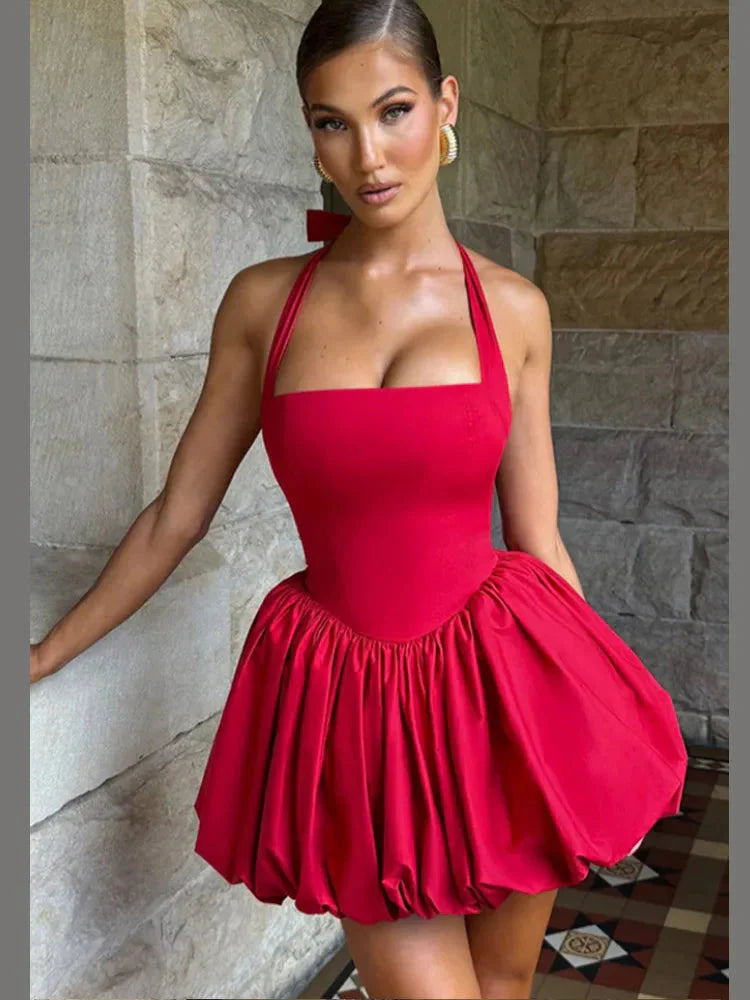 Women’s pink corset mini dress with puffball hem, casualwear style by FitiqueFit, shown on a model.