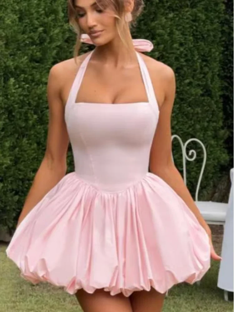 Pink women's corset puffball-hem mini dress from Plush Fashion Hub, featuring a fitted bodice and playful, flared hem.