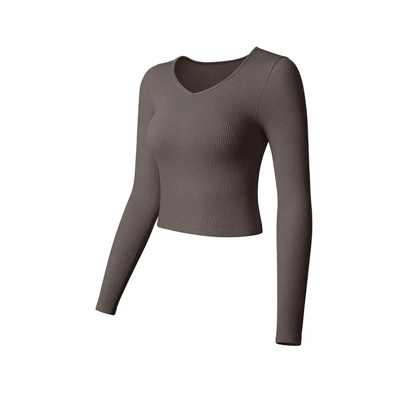 Plush Fashion Hub SculptFit long sleeve yoga crop top in casualwear style, shown in black with fitted design and stretchy fabric.