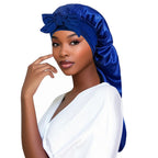 Women’s satin sleeping bonnet with long tail braid cover, ideal for sleep, shower, sauna, and bath, by Plush Fashion Hub.