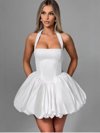 Women’s pink corset puffball-hem mini dress by FitiqueFit, featuring a fitted corset bodice and a playful puffball hem.