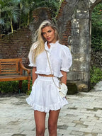 Women's ruffled linen-blend cropped blouse and shorts set by FitiqueFit, featuring lightweight fabric and stylish ruffle details.