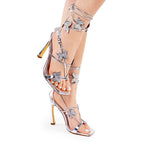 Silver Sasha-5 heels by The House of Stylez featuring stylish ankle straps and sleek pointed toes.