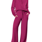 Women two-piece sweatshirt and wide-leg pants set by Plush Fashion Hub, featuring comfortable casual wear, shown in black and relaxed fit.