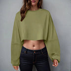 Women’s long sleeve loose-fit crop top by Plush Fashion Hub, casualwear in soft fabric, shown in a relaxed fit on a model.