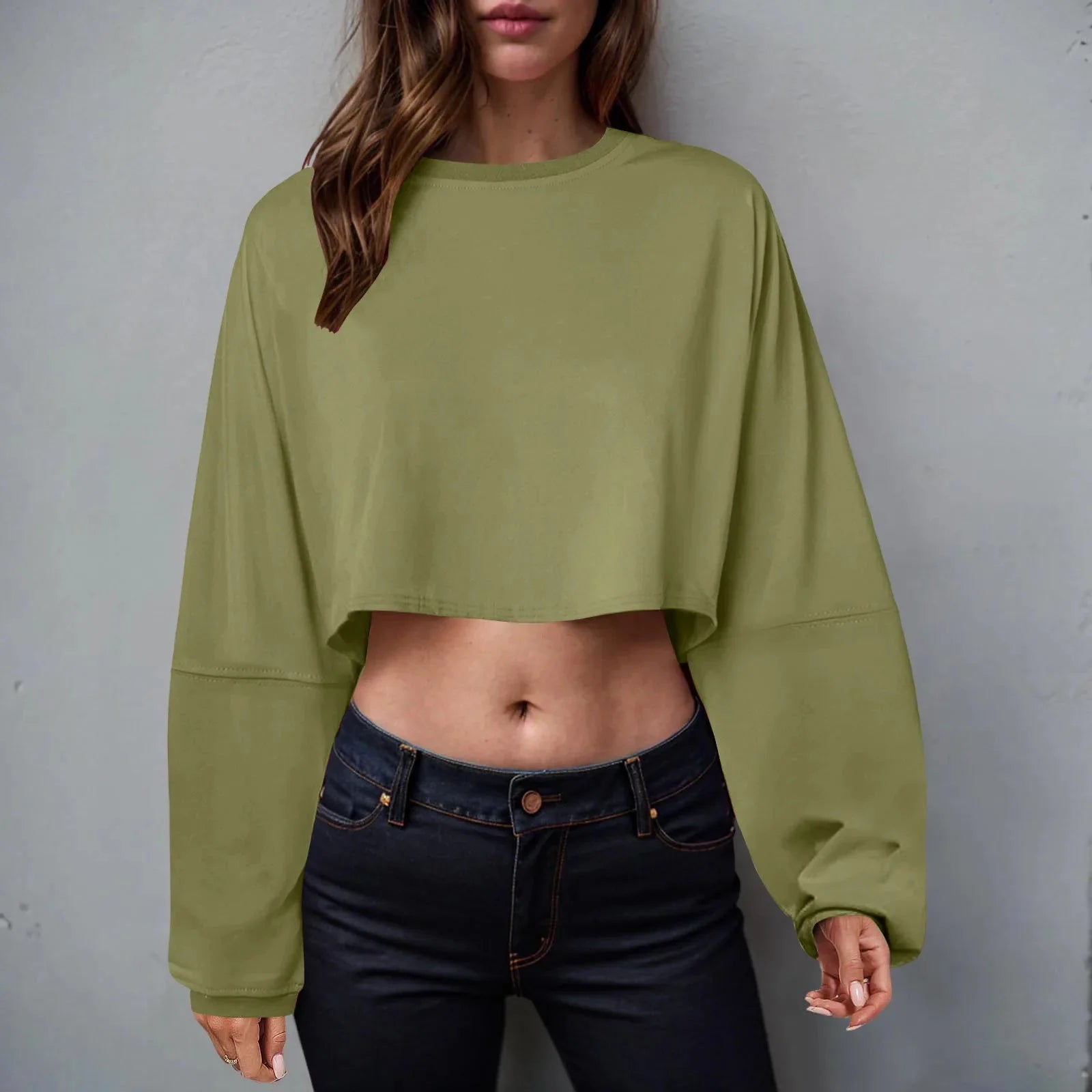 Women’s long sleeve loose-fit crop top by Plush Fashion Hub, casualwear in soft fabric, shown in a relaxed fit on a model.