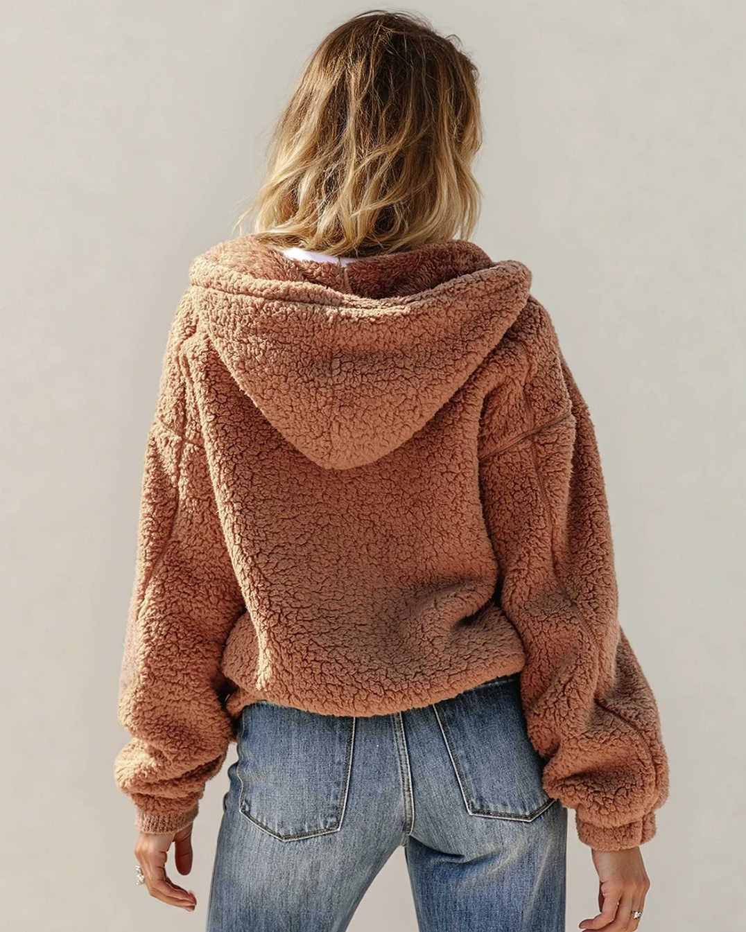 Indie & Co. Corrine zip-up hooded Sherpa jacket with soft fleece lining, shown on a hardwood floor background.