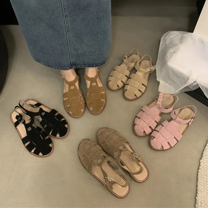 Dimanyu women's real leather Roman flat sandals with retro cage design, featuring open toe and ankle strap for a stylish look.