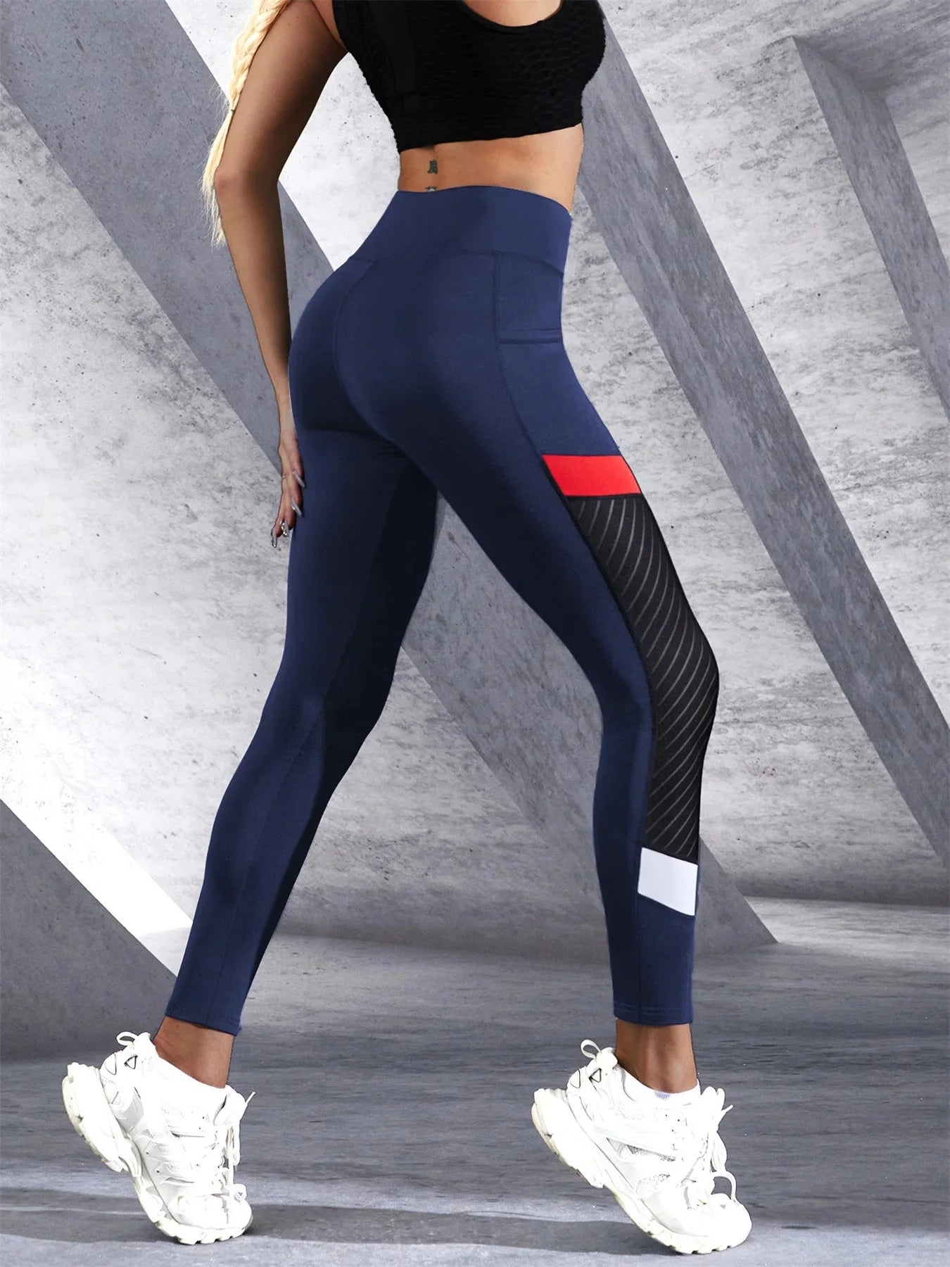 Black colorblocked mesh high-waist yoga leggings with side pockets from FitiqueFit activewear, featuring breathable fabric and a snug fit.