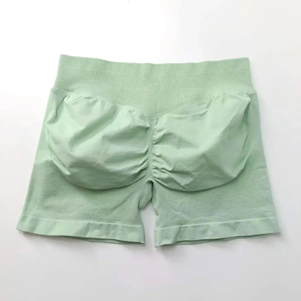 Women's seamless scrunch butt gym shorts in black, designed for high-performance fitness and yoga, from NCLAGEN Gym Wear.