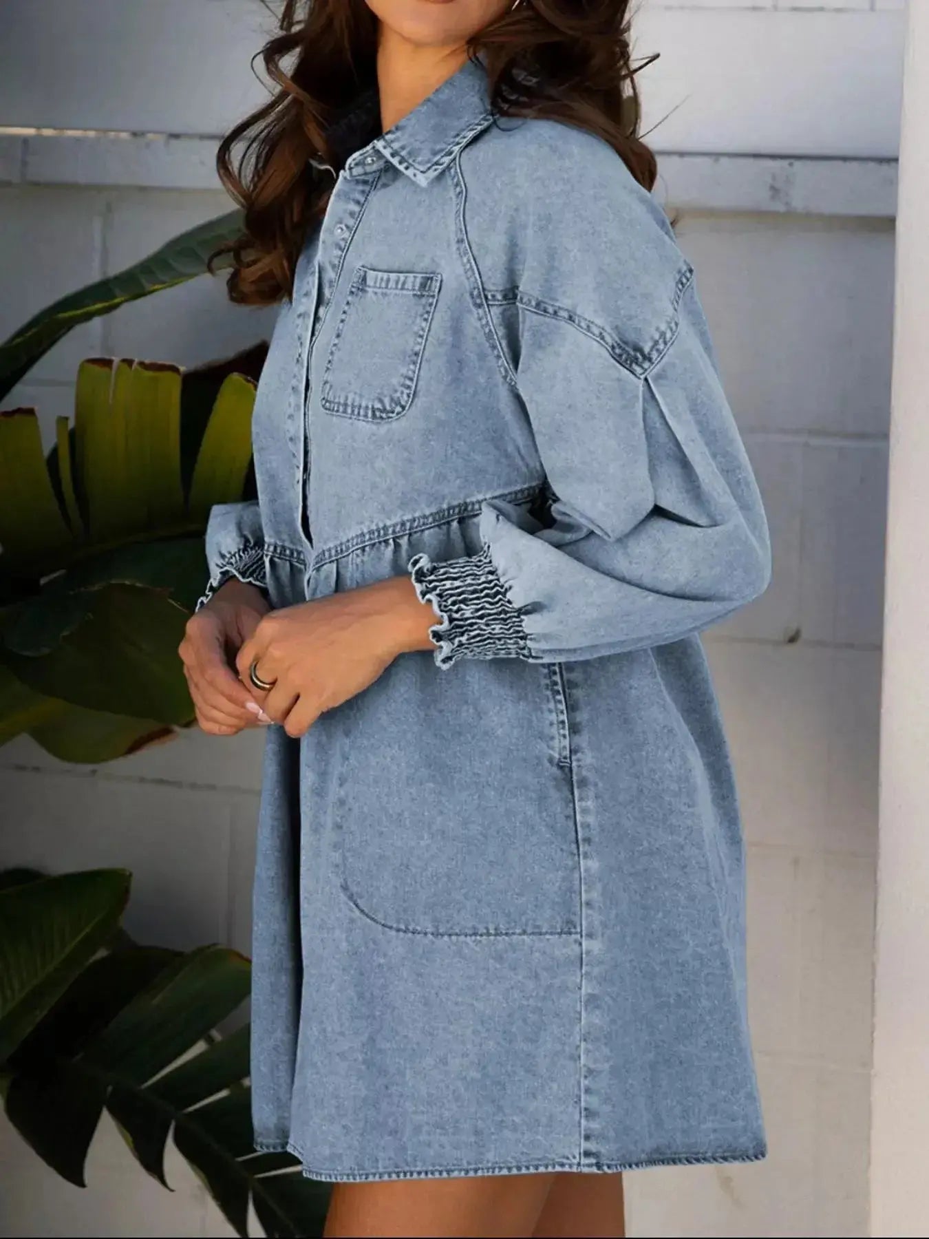 Smocked cuff flared denim shirt mini dress by Trendsi, casual button-down jean dress with fitted waist and flared hem.