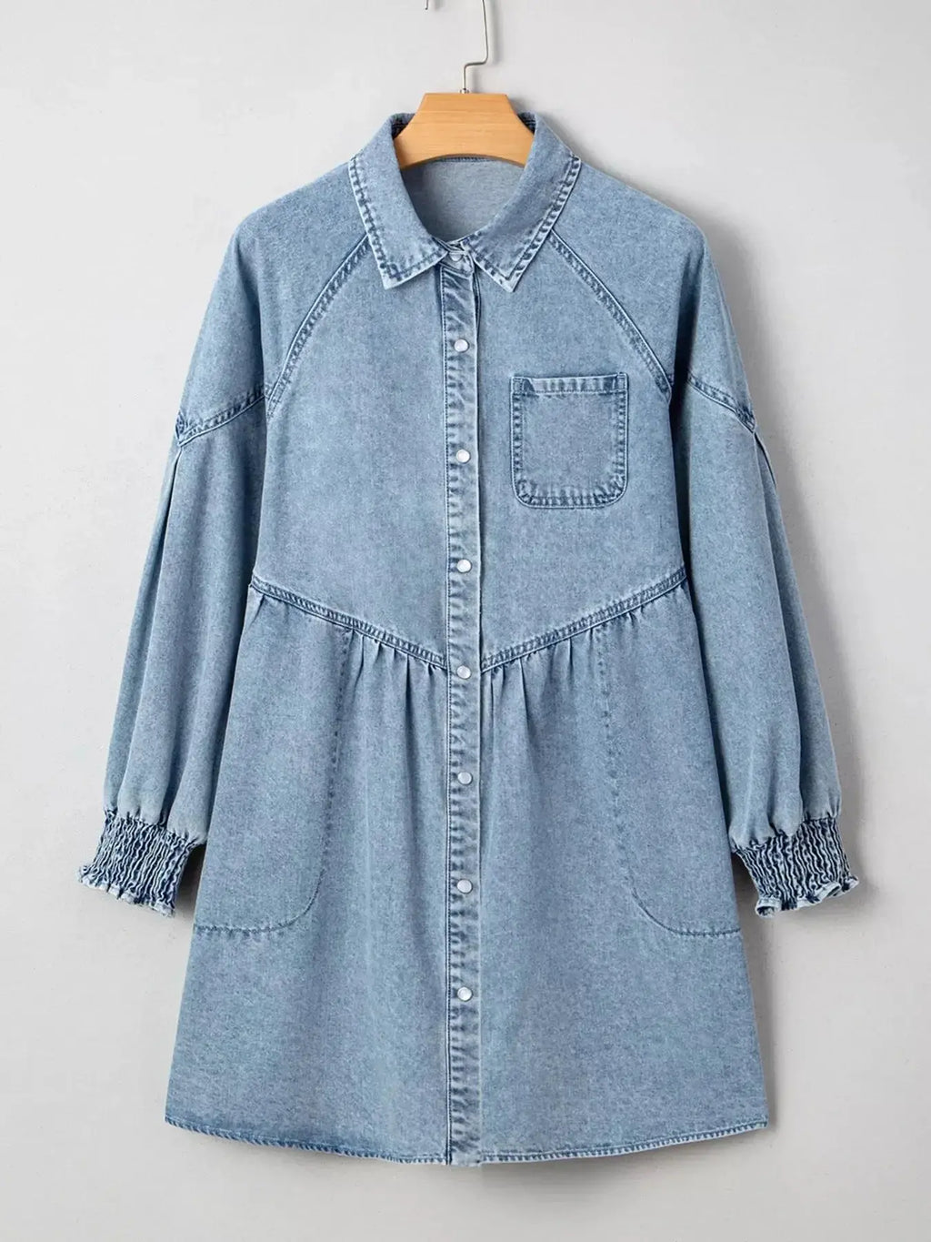 Casual denim mini dress with smocked cuffs, flared silhouette, button-down front, by Trendsi, perfect for a relaxed, stylish look.