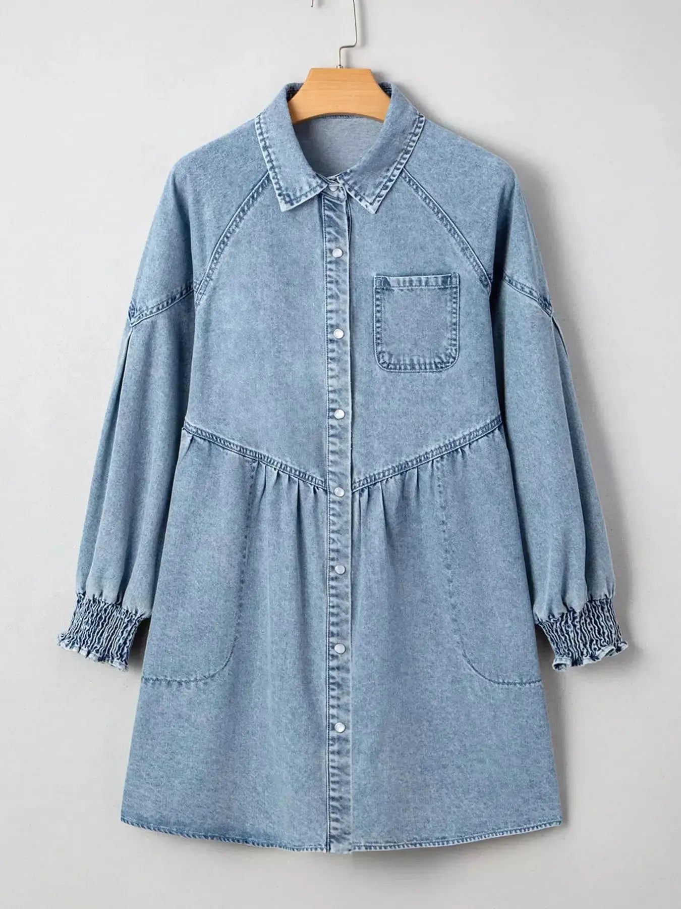 Casual denim mini dress with smocked cuffs, flared silhouette, button-down front, by Trendsi, perfect for a relaxed, stylish look.