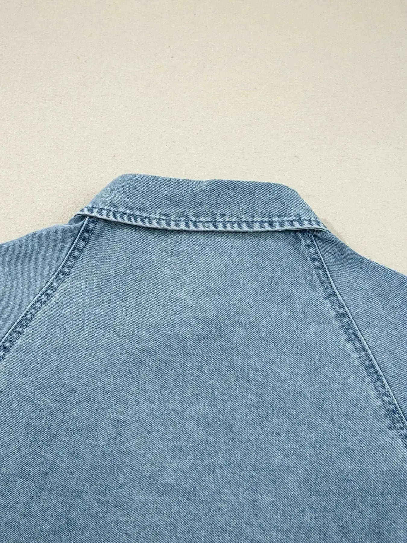 Casual denim mini dress with smocked cuffs, flared silhouette, button-down front, from Trendsi's smocked cuff flared denim shirt dress collection.