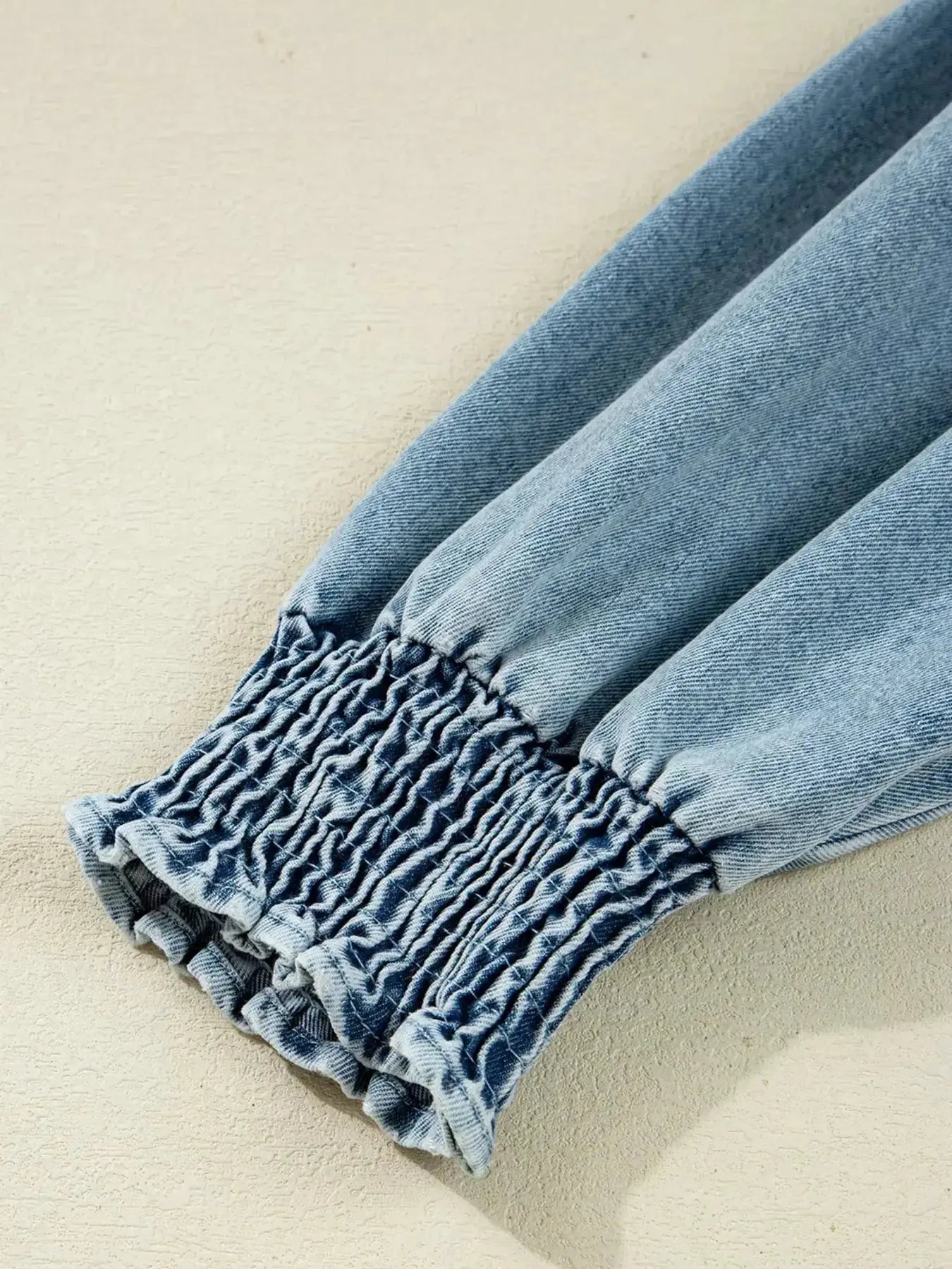 Casual denim mini dress with smocked cuffs and flared silhouette, featuring a button-down front, by Trendsi.
