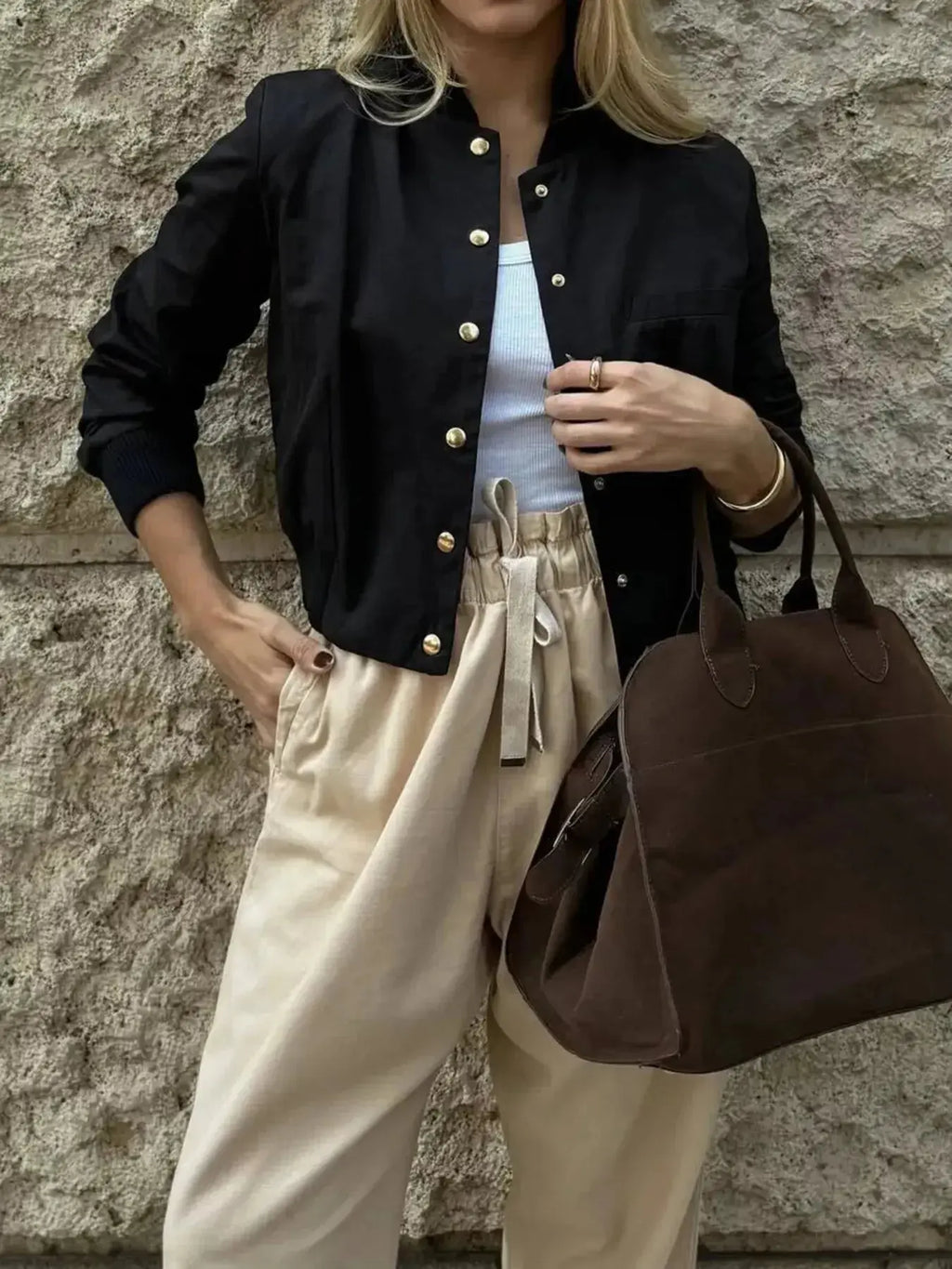 Lightweight women's cropped bomber jacket with snap buttons, casual outerwear from Trendsi, shown in a stylish outdoor setting.