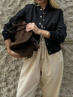 Women's cropped bomber jacket by Trendsi featuring snap buttons and lightweight casual outerwear style.