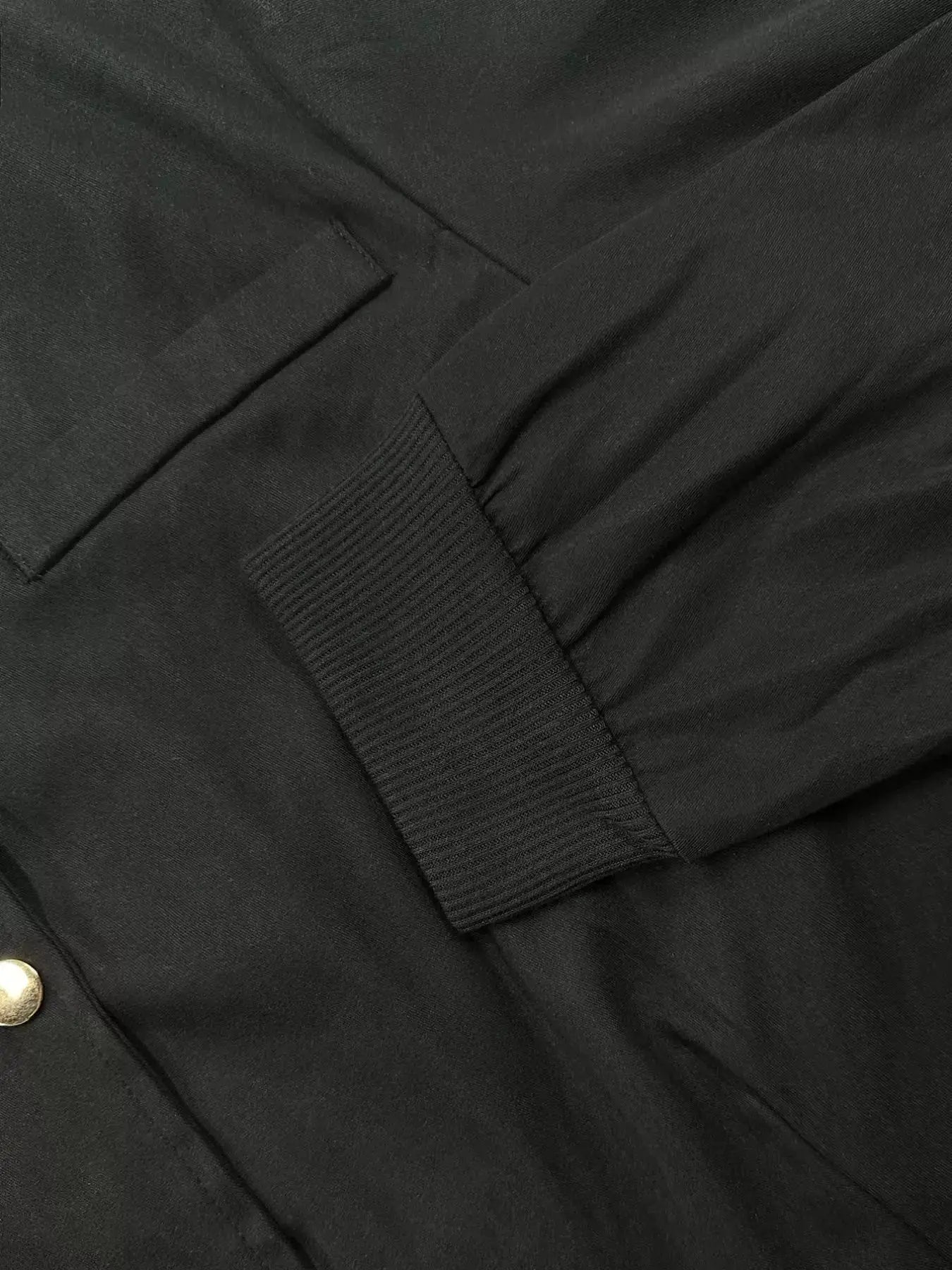 Women's lightweight cropped bomber jacket with snap buttons, casual outerwear by Trendsi, shown in a stylish, relaxed fit.