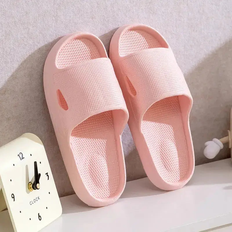 Solid-colored unisex bathroom slippers with thick soles and non-slip EVA bottoms, lightweight indoor slides by Plush Fashion Hub.