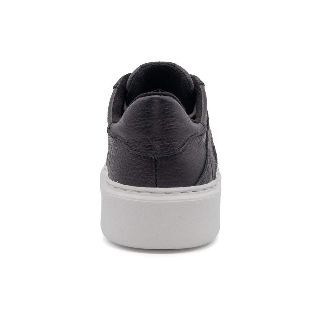 Black BLKSWN Footwear low-top sneaker with solid black design, shown from the back view.