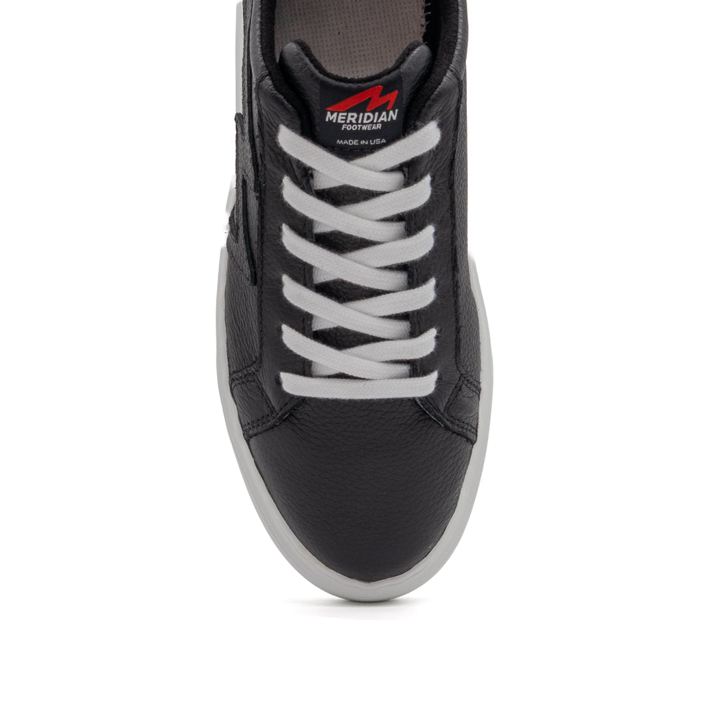 Black BLKSWN Footwear lowtop sneaker with solid black design, featuring a sleek and minimalistic style.