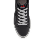 Black BLKSWN Footwear lowtop sneaker with solid black design, featuring a sleek and minimalistic style.