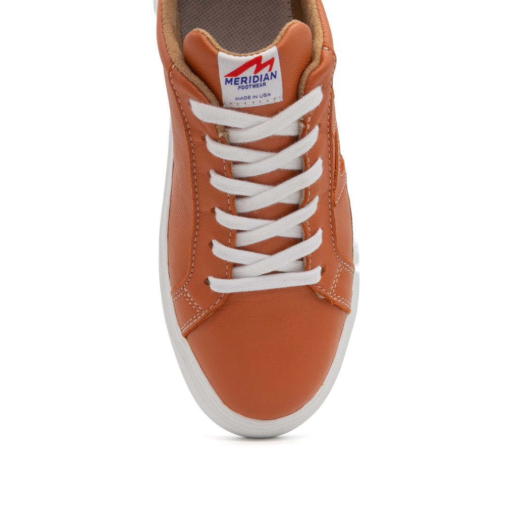 Burnt orange BLKSWN Footwear lowtop sneaker with solid color design, featuring a classic low-cut style and white sole.