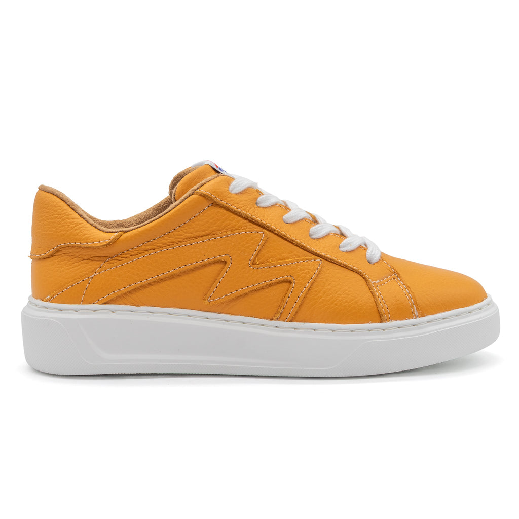 Right view of BLKSWN Footwear 601 Solid Gold low-top sneaker showing gold-colored canvas and white rubber sole.