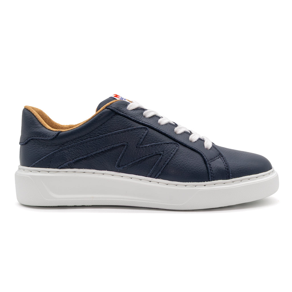 Navy blue BLKSWN Footwear lowtop sneaker with solid color design, right shoe displayed against a neutral background.