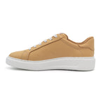 Black BLKSWN Footwear lowtop sneaker in old gold with solid color design, shown from the left side.