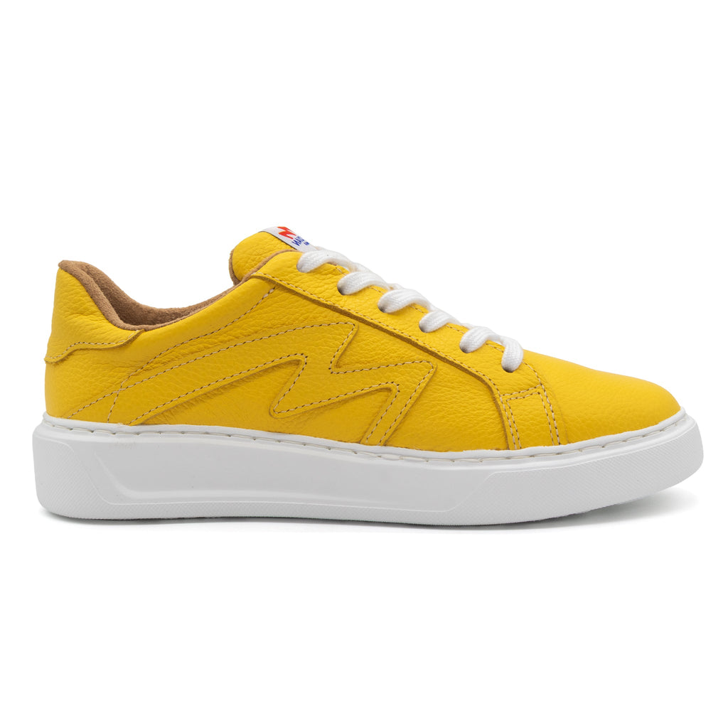 Yellow BLKSWN Footwear lowtop sneaker in solid yellow, right side view showing stylish canvas design.