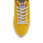 Yellow BLKSWN Footwear lowtop sneaker with solid yellow canvas upper and white sole.