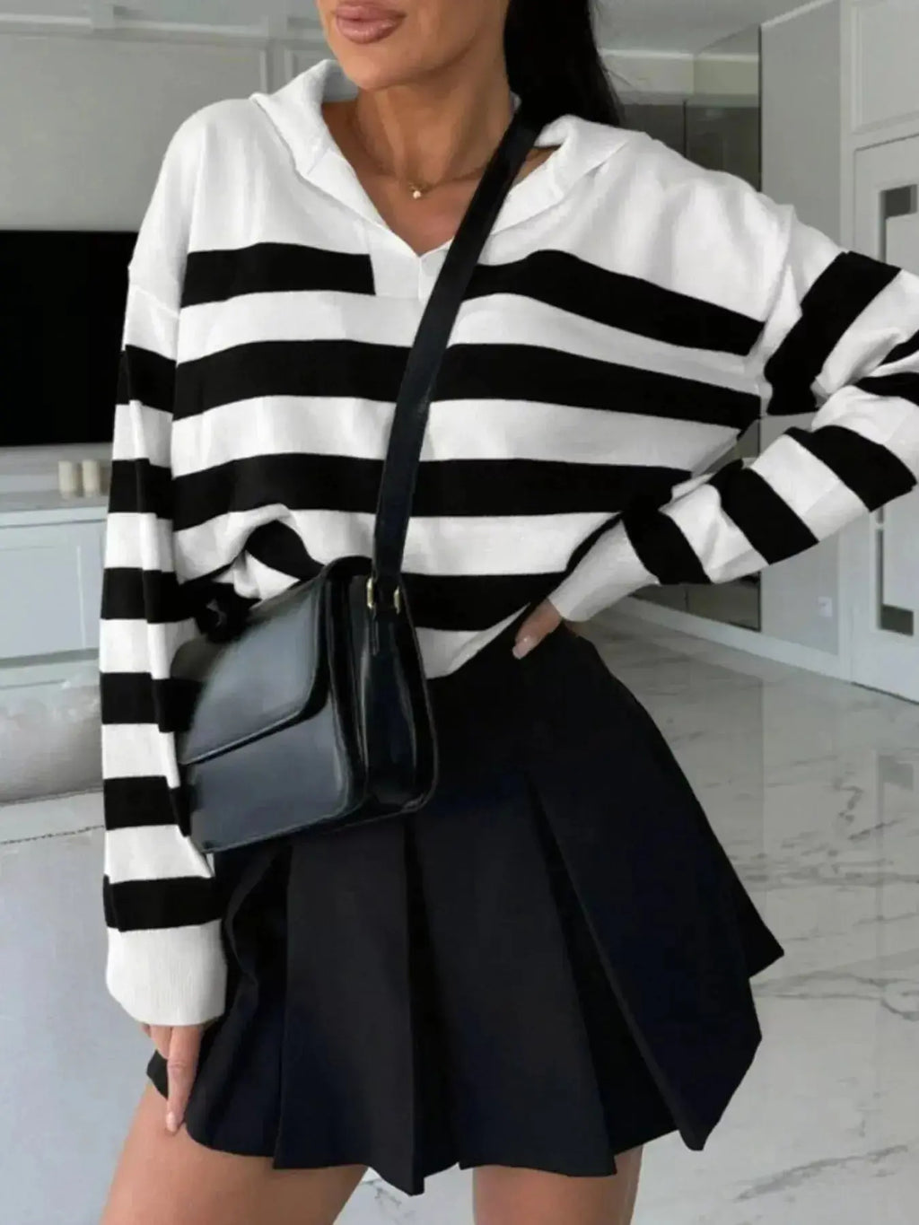 Women's striped dropped shoulder knit sweater top by Plush Fashion Hub, featuring long sleeves and casual, stylish design.