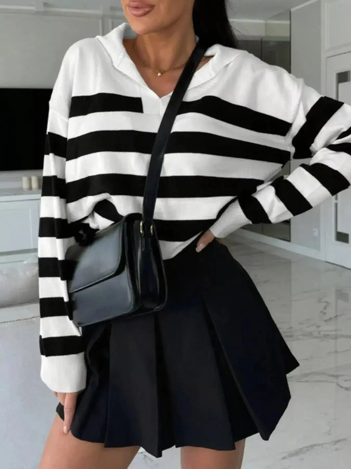 Women's striped dropped shoulder knit sweater top by Plush Fashion Hub, featuring long sleeves and casual, stylish design.