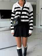 Women's striped dropped shoulder knit sweater top by Plush Fashion Hub, featuring long sleeves and casual style.
