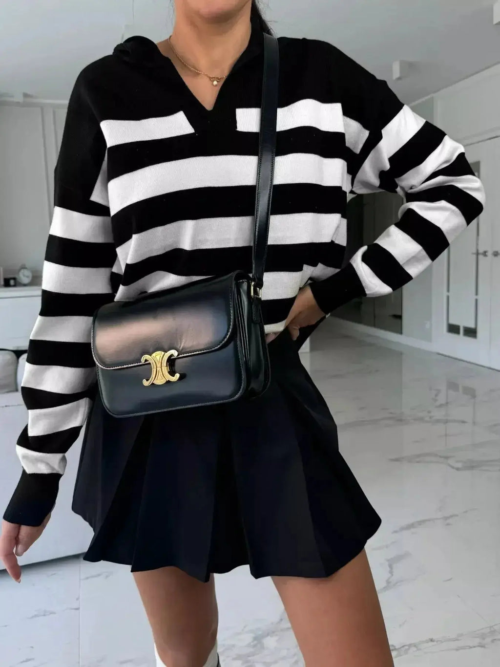 Women's striped dropped shoulder knit sweater top with long sleeves from Plush Fashion Hub, casual and comfortable for everyday wear.