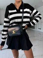 Women's striped dropped shoulder knit sweater top with long sleeves from Plush Fashion Hub, casual and comfortable for everyday wear.