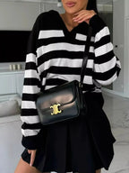 Women's striped dropped shoulder knit sweater top with long sleeves, casual and stylish from Plush Fashion Hub.