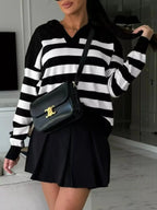 Women's striped dropped shoulder knit sweater top from Plush Fashion Hub, featuring long sleeves and a casual relaxed fit.